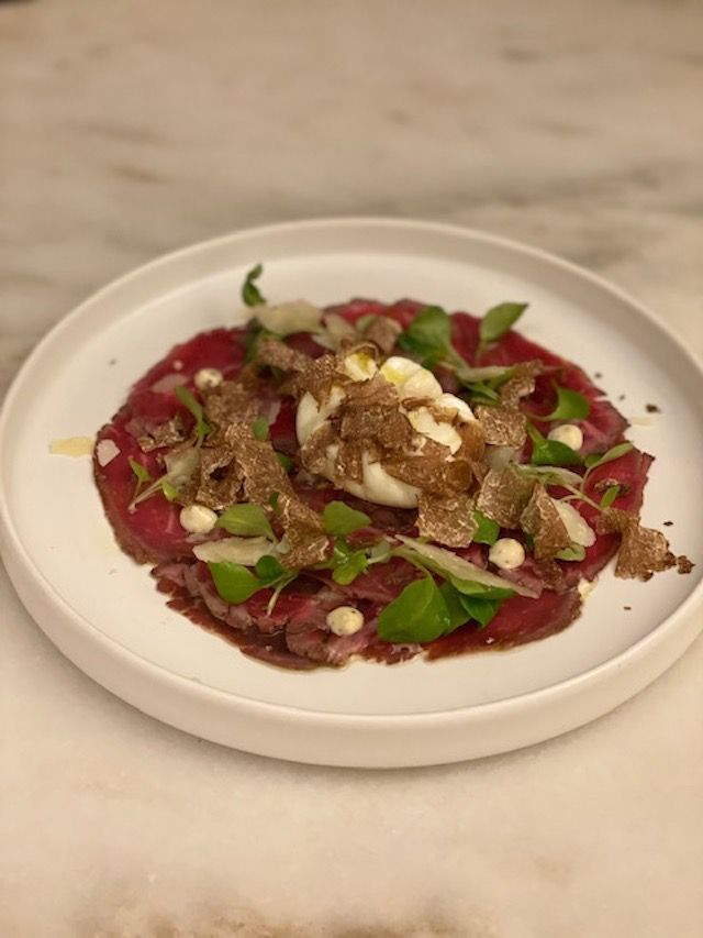 This is a photo of truffle carpaccio at an NYC restaurant, Lumaca.
